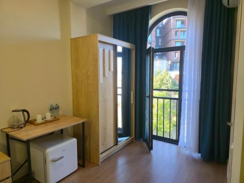 a room with a door open to a balcony at Hotel Ere's Palace in Tbilisi City