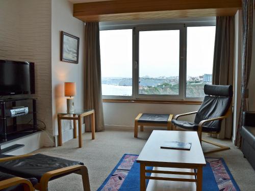 a living room with a room with a large window at Towan View in Newquay