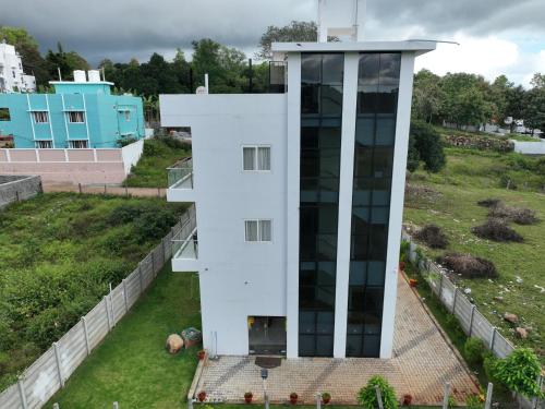 an aerial view of a white building at PRS CREEK SIDE HOME STAY VILLA in Yelagiri