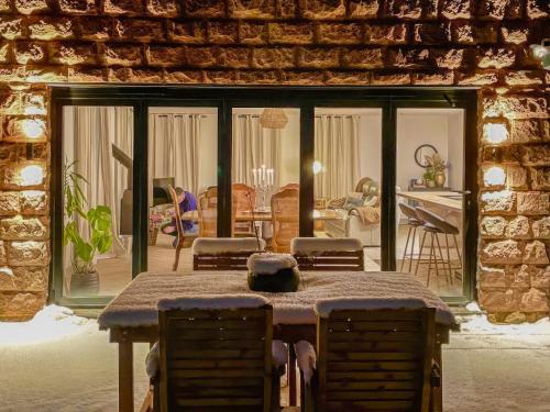 a room with a table and chairs and a living room at The Bungalow in Rushton Spencer