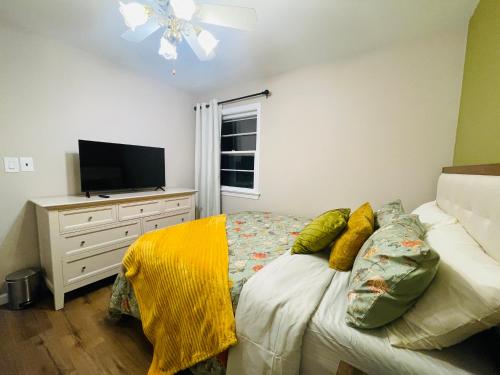 a bedroom with a bed and a dresser with a television at Private Estate, Walk to Princeton Downtown, 3-Bedrooms 2-Bath with Free Parking in Princeton