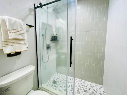 a bathroom with a glass shower with a toilet at Private Estate, Walk to Princeton Downtown, 3-Bedrooms 2-Bath with Free Parking in Princeton