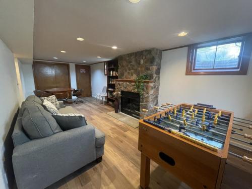 a living room with a couch and a game table at Private Estate, Walk to Princeton Downtown, 3-Bedrooms 2-Bath with Free Parking in Princeton