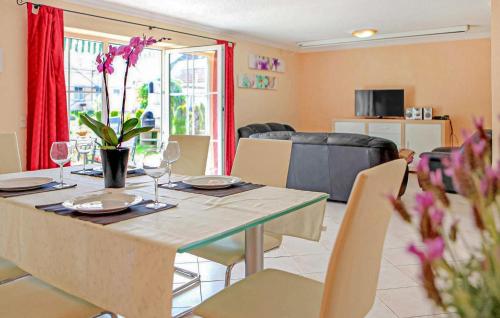 a dining room with a table with glasses and flowers on it at Ferienhaus Verchen in Verchen