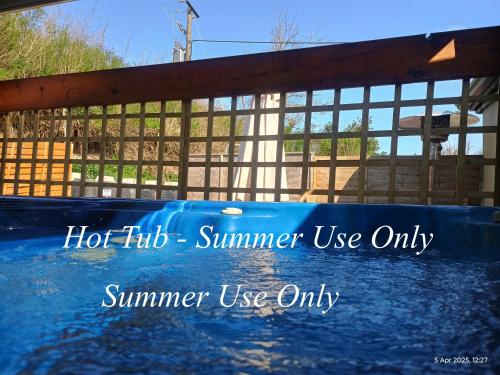 a hot tub summer use only sign in front of a fence at Matty's Pub - Apartment's in Carlow