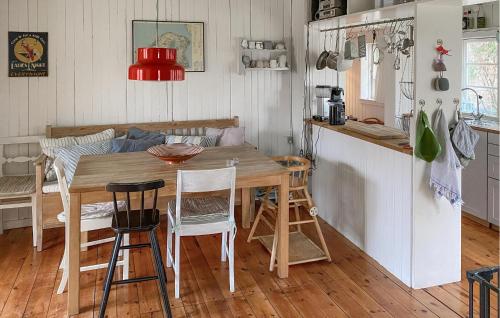 a kitchen and dining room with a wooden table and chairs at Cozy Home In Vejby With Wifi in Rågeleje