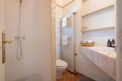 a bathroom with a shower and a toilet and a sink at House Beach & Golf Costa de los Pinos in Costa des Pins
