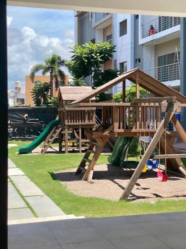 a park with a wooden playground with a slide at Portezza Natura in Mazatlán