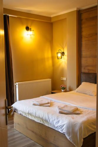 a bedroom with a bed with two towels on it at Mestia Roots in Mestia