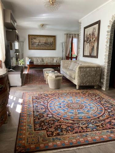 a living room with a couch and a rug at VILLA ROMA Resort in Vallecrosia