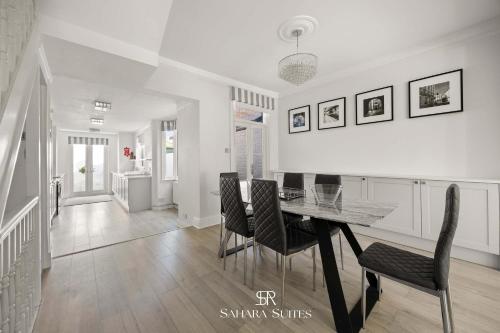 a dining room with a table and chairs at New Stylish 4BR - Windsor City Centre - Sleeps 6 in Windsor
