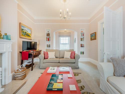 a living room with a couch and a table at The Anchorage in Pembroke