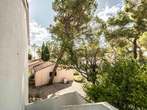 a view from a window of a house with trees at Zaton Holiday Resort in Nin