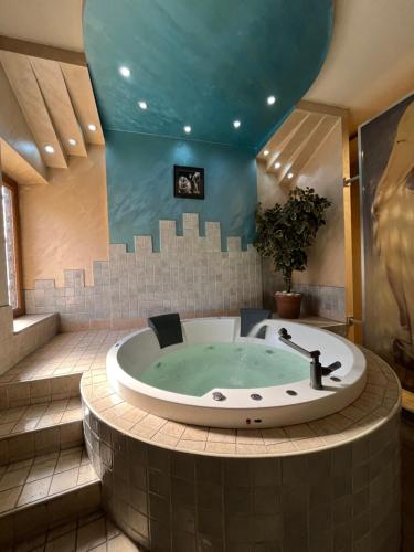 a jacuzzi tub in a bathroom with a blue ceiling at Amor fati in Yerevan