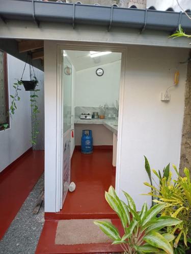 an open door to a kitchen in a house at Rosy guest house. in Mirissa