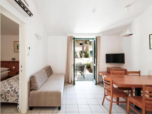 a living room with a couch and a table at Zaton Holiday Resort in Nin