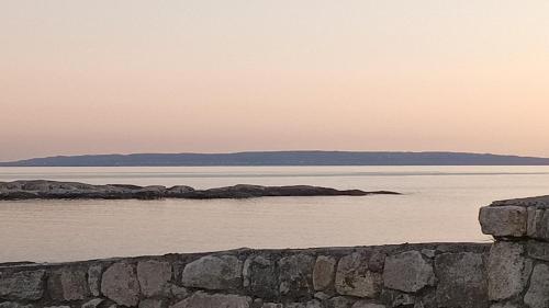 a large body of water with a stone wall at Atlantic beach house in Dog Island