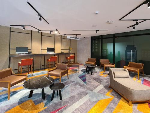 a lobby with chairs and tables in a room at Holiday Inn Cebu City by IHG in Cebu City