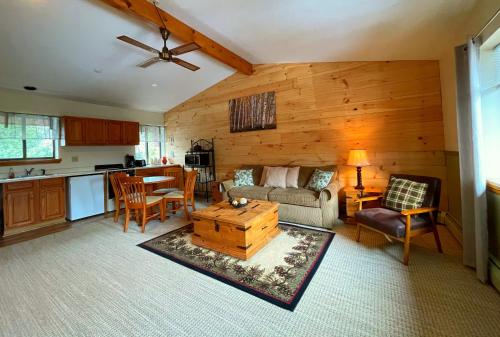 a living room with a couch and a table at The Snowed Inn in Killington