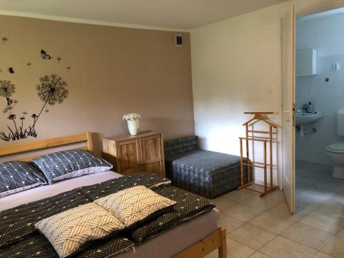 a bedroom with a bed and a bathroom with a sink at PäRLAN APARTMAN in Balatonboglár