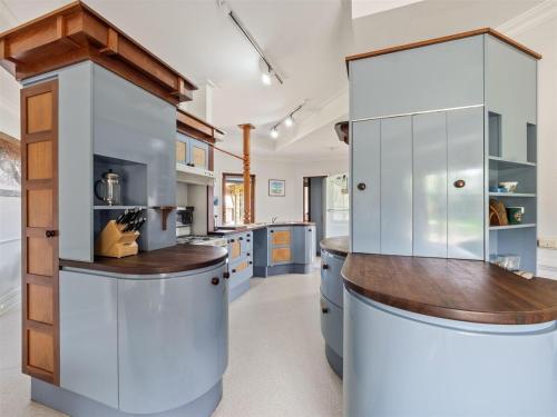 a large kitchen with white cabinets and a wooden counter at Mooring B on the shoreline in Augusta