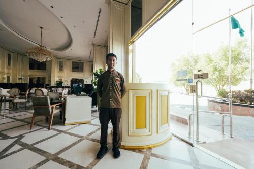 a man standing in a room in a building at Verta Quraish Hotel in Jeddah