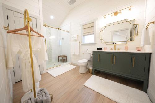 a bathroom with a green cabinet and a sink at Laurel Court Cottages- A Pickleball Getaway in Fredericksburg