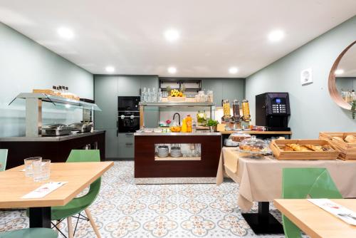 a restaurant with tables and a counter with food at Quinta do Moinho in Loulé