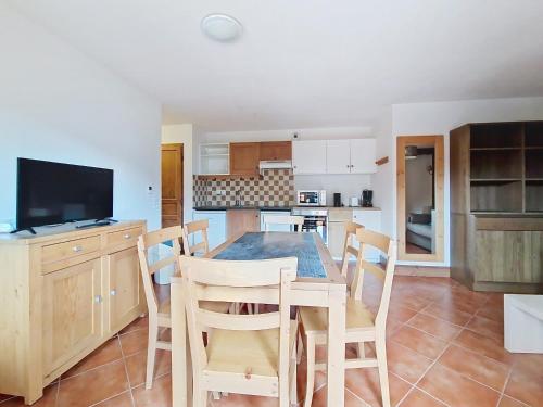 a kitchen with a dining room table and chairs at Grand Lodge GRA13 SPA & MOUNTAIN 6 Pers in Châtel