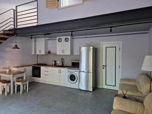 a kitchen with a stainless steel refrigerator and a table at apartments Lviv Vernygory 14 in Lviv