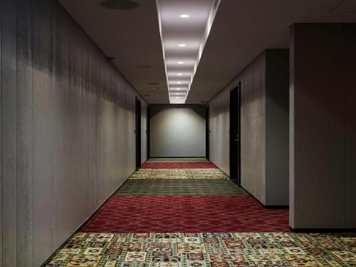 an empty corridor with a corridorngthngthngthngthngthngthngth at Tango Inn Taipei Jihe in Taipei