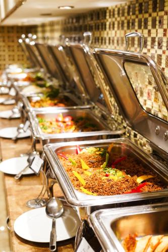 a row of trays of food in a buffet at Verta Quraish Hotel in Jeddah