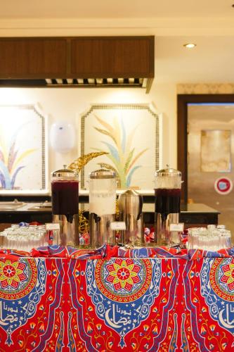 a table with a red and blue table cloth on it at Verta Quraish Hotel in Jeddah