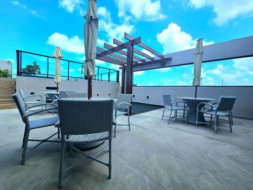 a patio with chairs and tables on a roof at O Melhor do Cupe no Cupe Exclusive COM e SEM Piscina privativa by HM in Porto De Galinhas