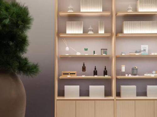 a shelf with bottles and other items on it at KongGang airport hotel & free shuttle bus in Guangzhou