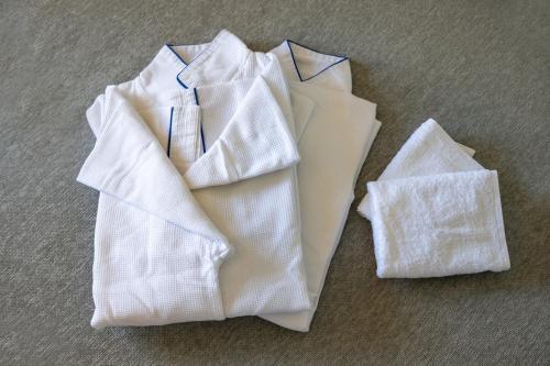two white towels sitting on the floor next to each other at ANA Holiday Inn Iwate Kitakami by IHG in Kitakami