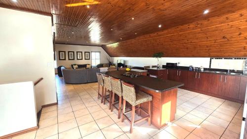 a kitchen with a table and chairs in a room at Langebaan at Amorgos 3 in Langebaan