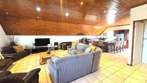 a large living room with couches and a kitchen at Langebaan at Amorgos 3 in Langebaan
