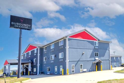 a large building with a sign in front of it at Burgundy Inn & Suites in El Paso