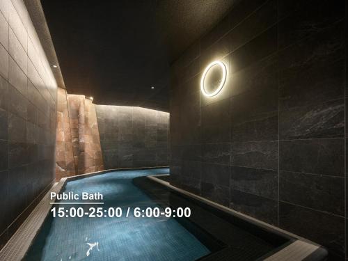 a pool in a bathroom with a moon on the wall at Mitsui Garden Hotel Ginza Tsukiji in Tokyo