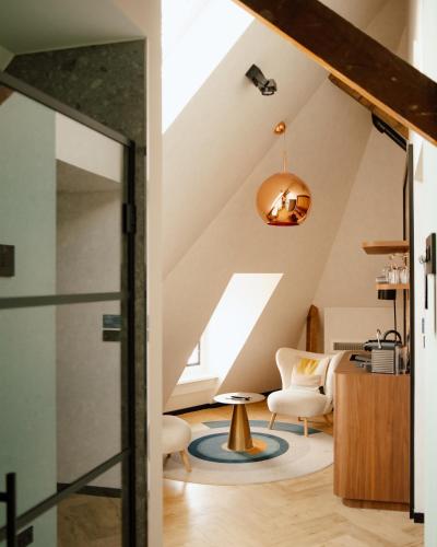 an attic living room with a vaulted ceiling at Ocean House Scheveningen in Scheveningen