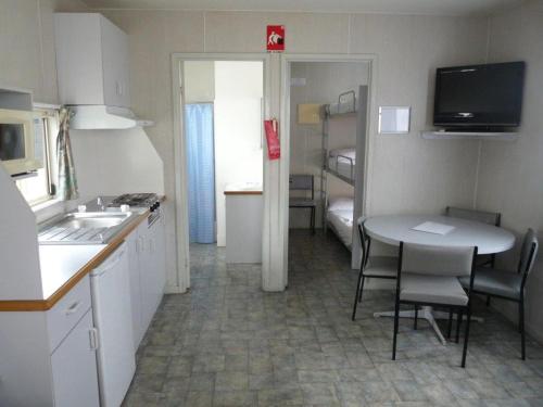a kitchen with a sink and a microwave at Wodonga Caravan & Cabin Park in Wodonga