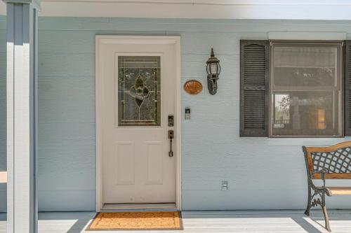 a blue house with a white door and a window at 8-Acre Retreat Pool and Stunning Mt Lassen View! in Palo Cedro