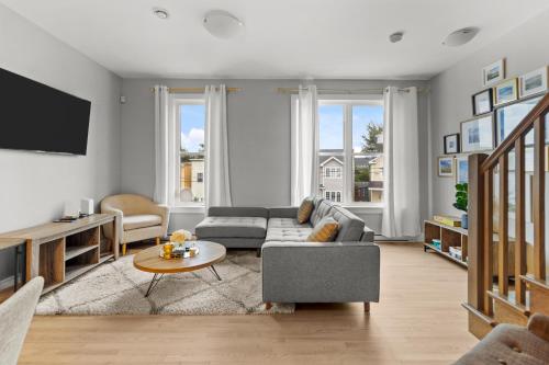 a living room with a couch and a table at Pennywell Prestige 3BR 25BA Garage in St. John's
