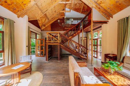 a living room with a staircase in a house at Under The Shade Safari Lodge in Arusha