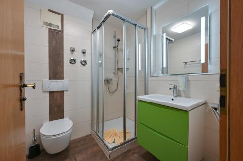 a bathroom with a shower and a toilet and a sink at Hotel San Marco in Füssen
