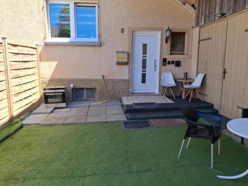 a backyard with a patio with a fire place at Erdgeschoss 75 m2 Großer Parkplatz WLAN Terrasse 30 m2 Übernachtung Unterkunft in Talheim