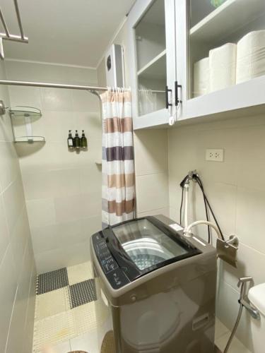a bathroom with a sink and a shower at Executive Studio Condo Unit 2 at Marina Spatial in Piapi