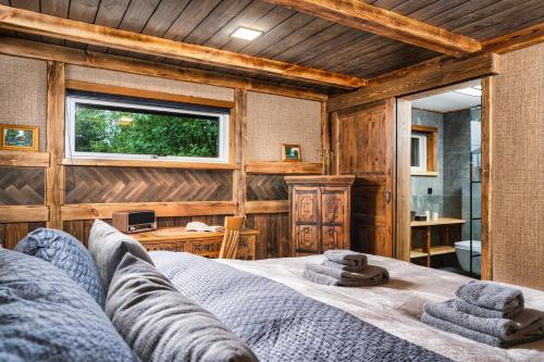 a bedroom with a bed with towels on it at Riverside Cabin - Hot Tub, Fishing and Relaxing Escape in Laugarvatn