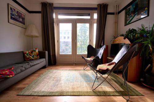 a living room with two chairs and a couch at Olympic's Little Palace in Amsterdam